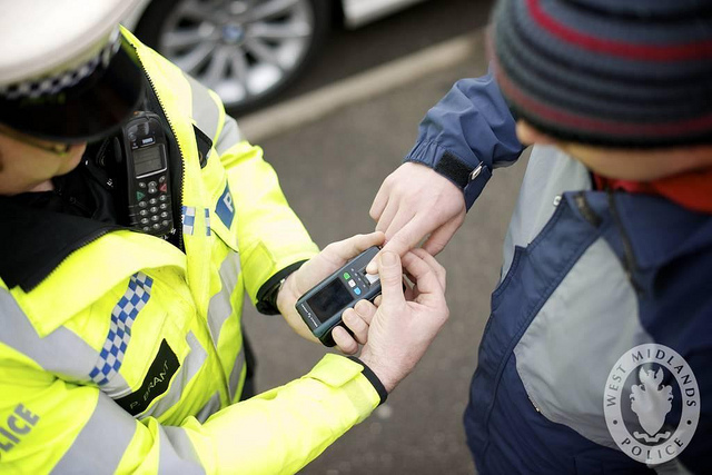 policeman scans fingerprint